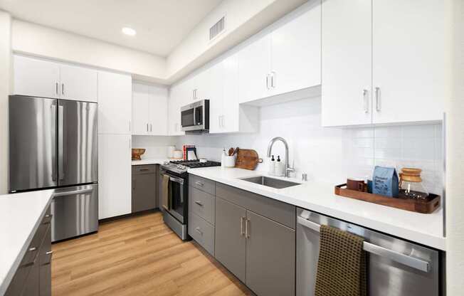 A modern kitchen with stainless steel appliances and wooden floors at The Villas at Anacapa Canyon, Camarillo, 93012