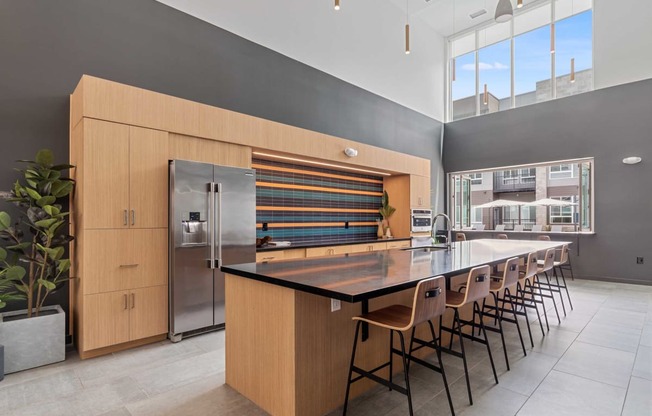 a large kitchen with a long island with chairs