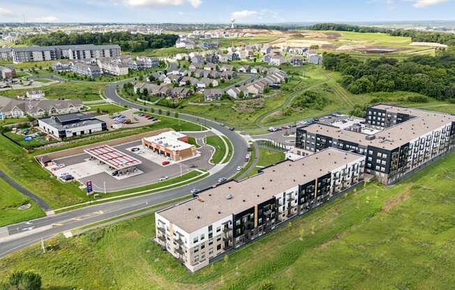 A large building complex with a parking lot in front.