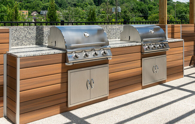two stainless steel barbecue grills next to each other on a patio at The Heights Apartments, Ohio, 45220