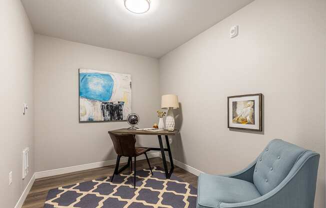 134th street lofts second bedroom with blue chair and desk