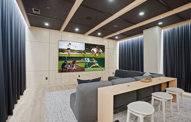 a living room with a couch and a tv on the wall