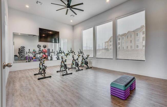 the home has a workout room with a slew of exercise bikes  at Affinity 56 Apartments in West Jordan, Utah