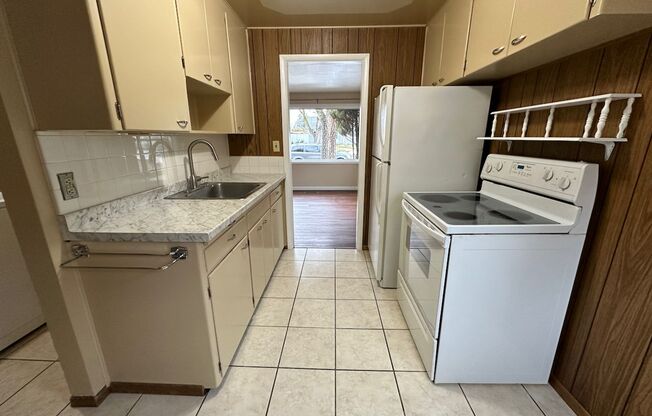 Cozy and Conveniently Located 2 Bed 1 Bath Spokane Home w/ Detached Garage & Heated Multipurpose Room!