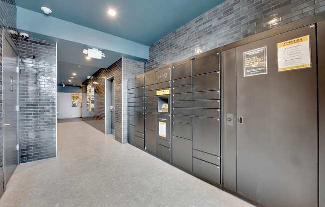 a row of stainless steel lockers in a hallway of a building