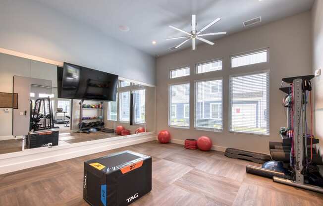 a home gym with a tv and exercise equipment