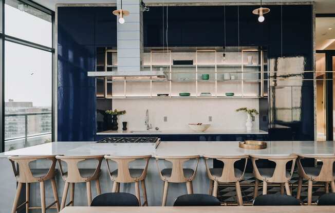 a kitchen with a long table and chairs in front of a kitchen counter at The Lively, Jersey City, NJ