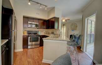 a kitchen with a breakfast bar and a fireplace