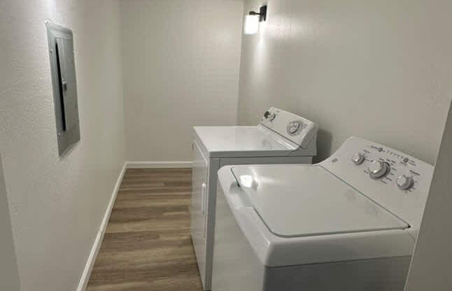 A laundry room with two washing machines.