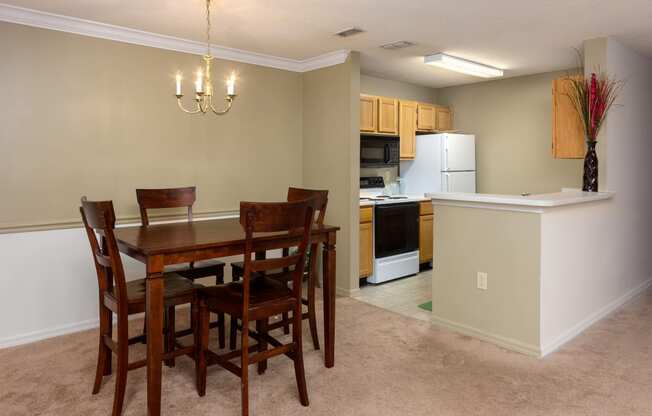 Dining area and kitchen with bar at Regency Gates in Mobile, AL