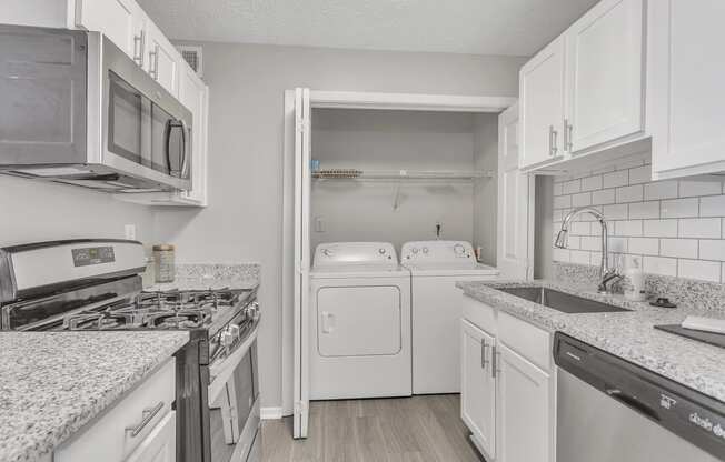 a kitchen with white appliances and granite counter tops