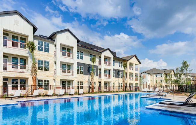 a swimming pool is in front of an apartment building at Legacy at Cibolo, Boerne, TX, 78006