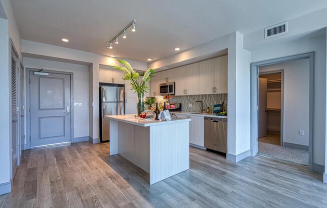 Open kitchen with a chef island, bright finishes, and plenty of room for casual gathering.