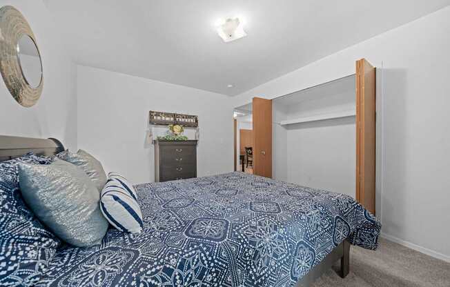 Comfortable bedroom with natural lighting at Westwood Village Apartments in Westland, MI