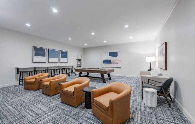 A room with grey carpet and a white wall with a painting on it.