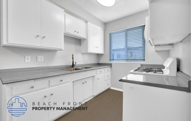 an image of a kitchen with white cabinets and a sink