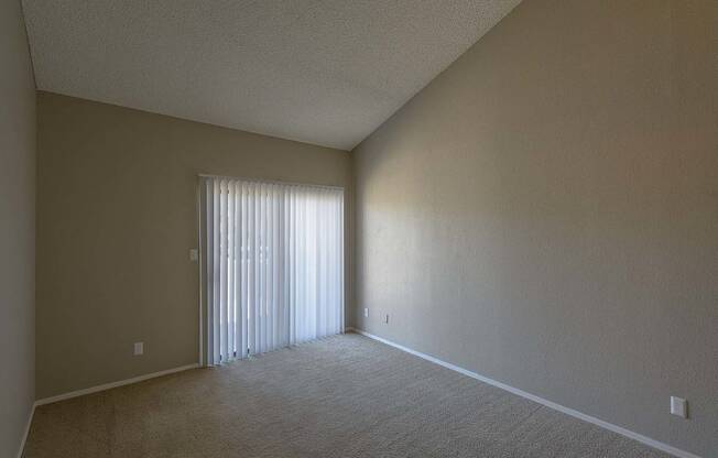 an empty living room with a window and