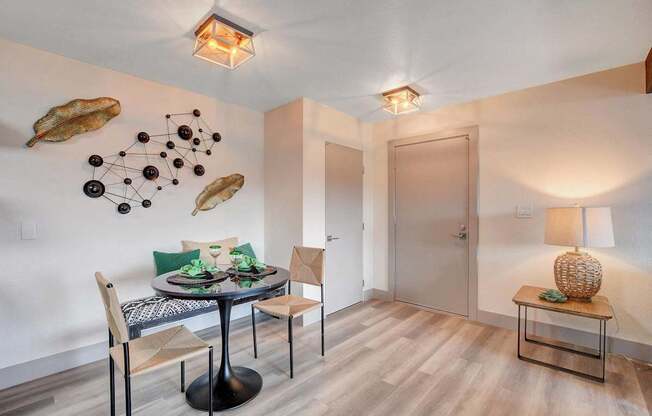 A dining room with a round table and chairs.