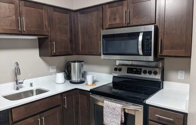 a kitchen with a stove microwave and sink