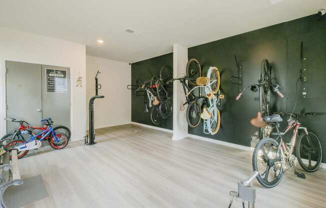 a room with bikes on the wall and a wood floor