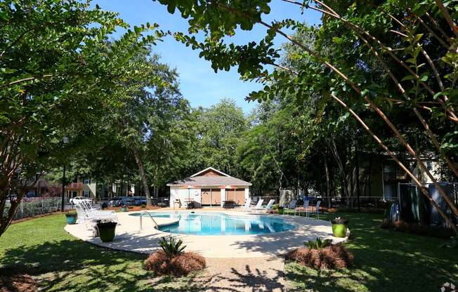a backyard with a pool and a pool house