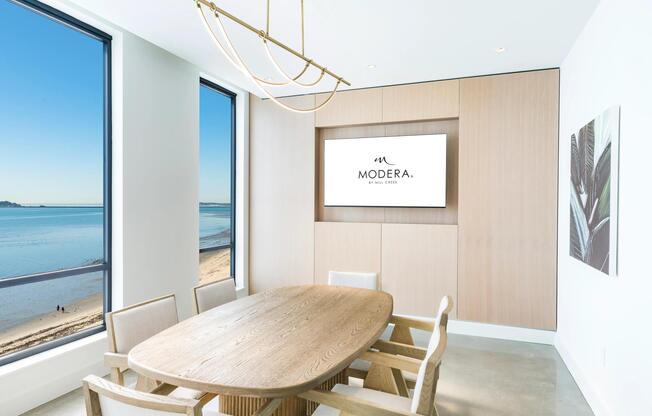 A refined conference space with warm wood tones and expansive water views designed to impress.