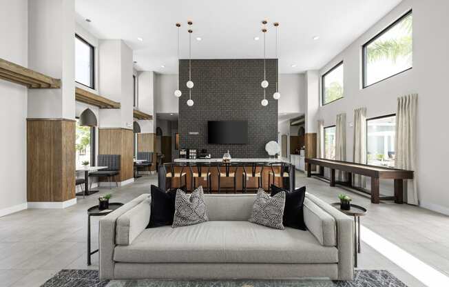 a living room with a couch and a bar in a lobby at The Sophia, Venice, FL, 34275