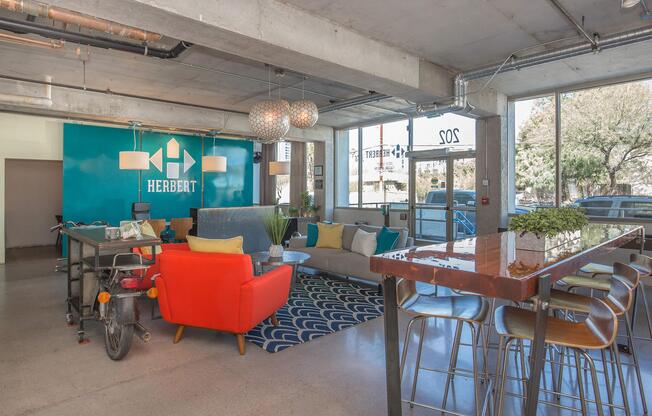 a room filled with furniture and a table in front of a building