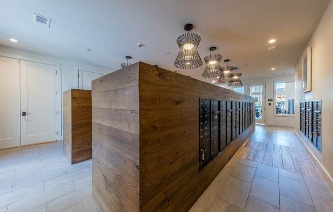 A long hallway with a wooden wall and black doors on the side.