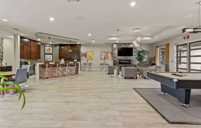 A spacious kitchen and living room with a pool table.