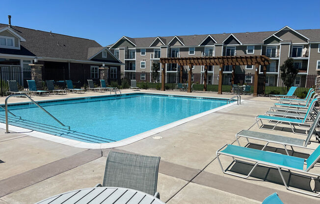 Sparkling Pool beside Community Building at Copper Creek Apartment Homes in Maize, Kansas