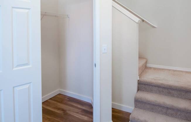 a renovated living room with stairs and a closet