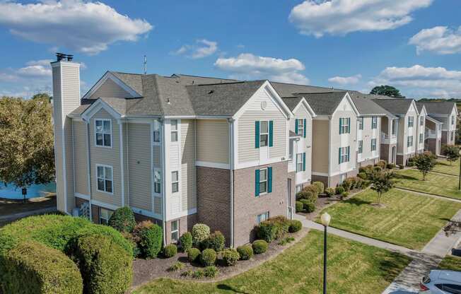 an aerial view of a row of apartments with grass and trees