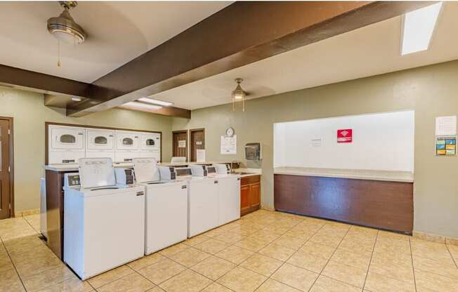 a laundry room with washers and dryers