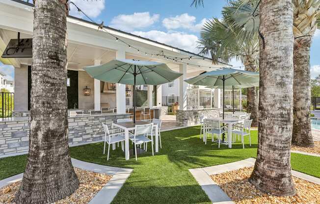 a patio with tables and chairs and umbrellas at Drift, Daytona Beach, FL, 32117