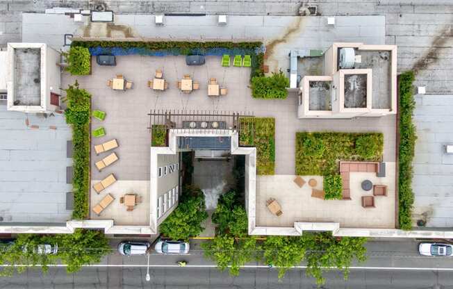 arial view of a building with greenery on the side of it