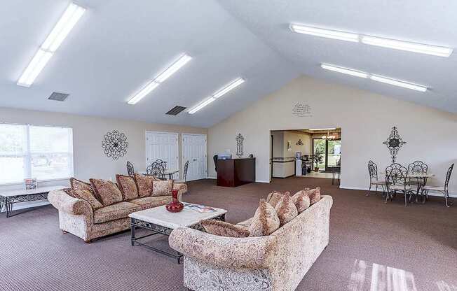 A living room with a couch, chairs, and a coffee table.