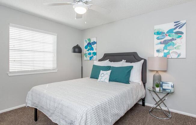 a bedroom with a bed and a ceiling fan