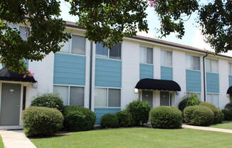 upgraded apartment homes with fresh paint, lush landscaping, and awnings over doors  at Huntsville Landing Apartments, Alabama