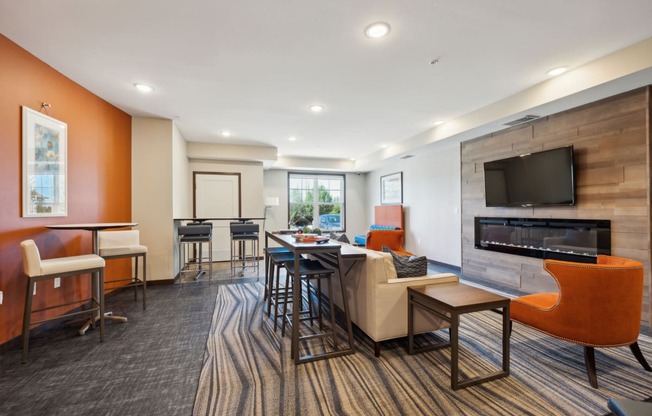 a living room with a fireplace and a table with chairs