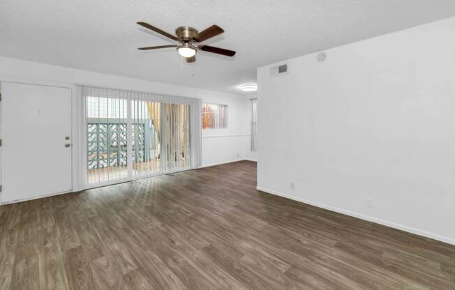 A room with a ceiling fan and wooden Floor at The Phoenix Apartments on 6th Avenue, Phoenix 85013