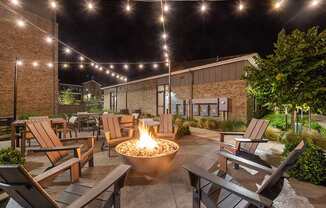 Outdoor Fire Pit Area with Lounge Furniture at Alta 3Eighty Apartments located in Aubrey, TX.