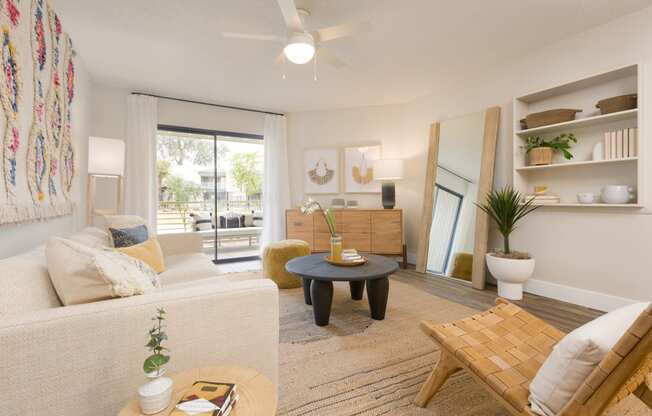 a living room with a white couch and a wooden coffee table