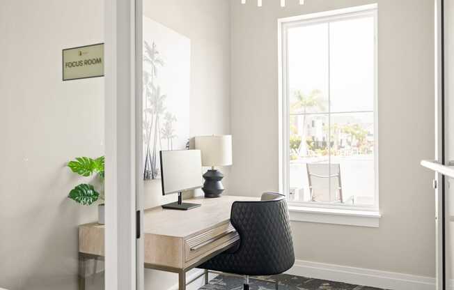 a home office with a desk and chair and a window at Palm Grove in Ellenton, FL 34222