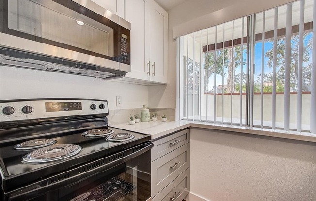 a kitchen with a stove and a microwave