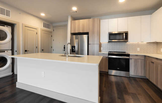 Kitchen with Stainless Steel Appliances and In-home Washer and Dryer