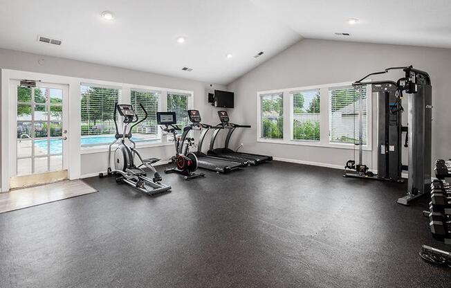 A spacious home gym with a variety of exercise equipment.