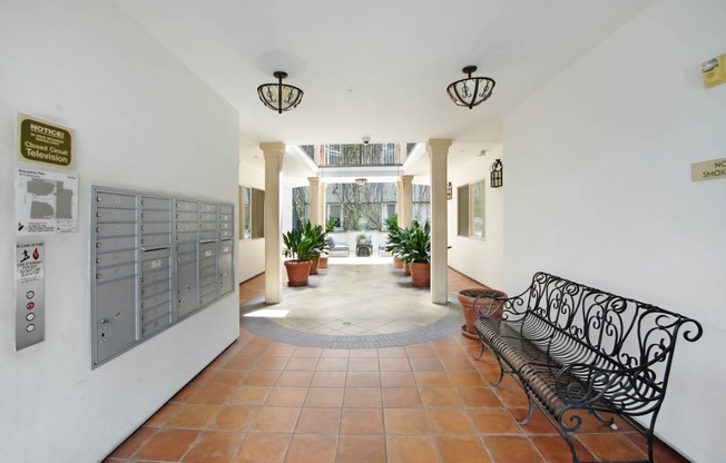 the lobby of a building with a bench and a door