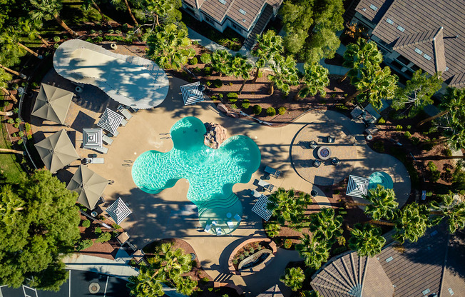 an aerial view of a swimming pool with blue water