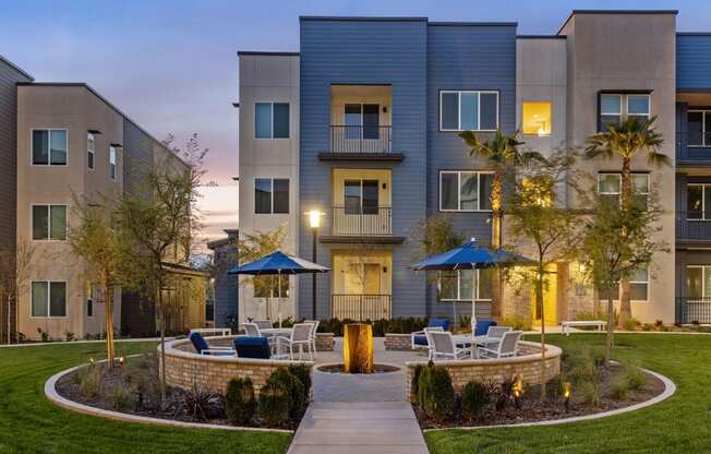 a courtyard with tables and chairs in front of an apartment buildingat Westbury Apartments, Rancho Cucamonga, CA